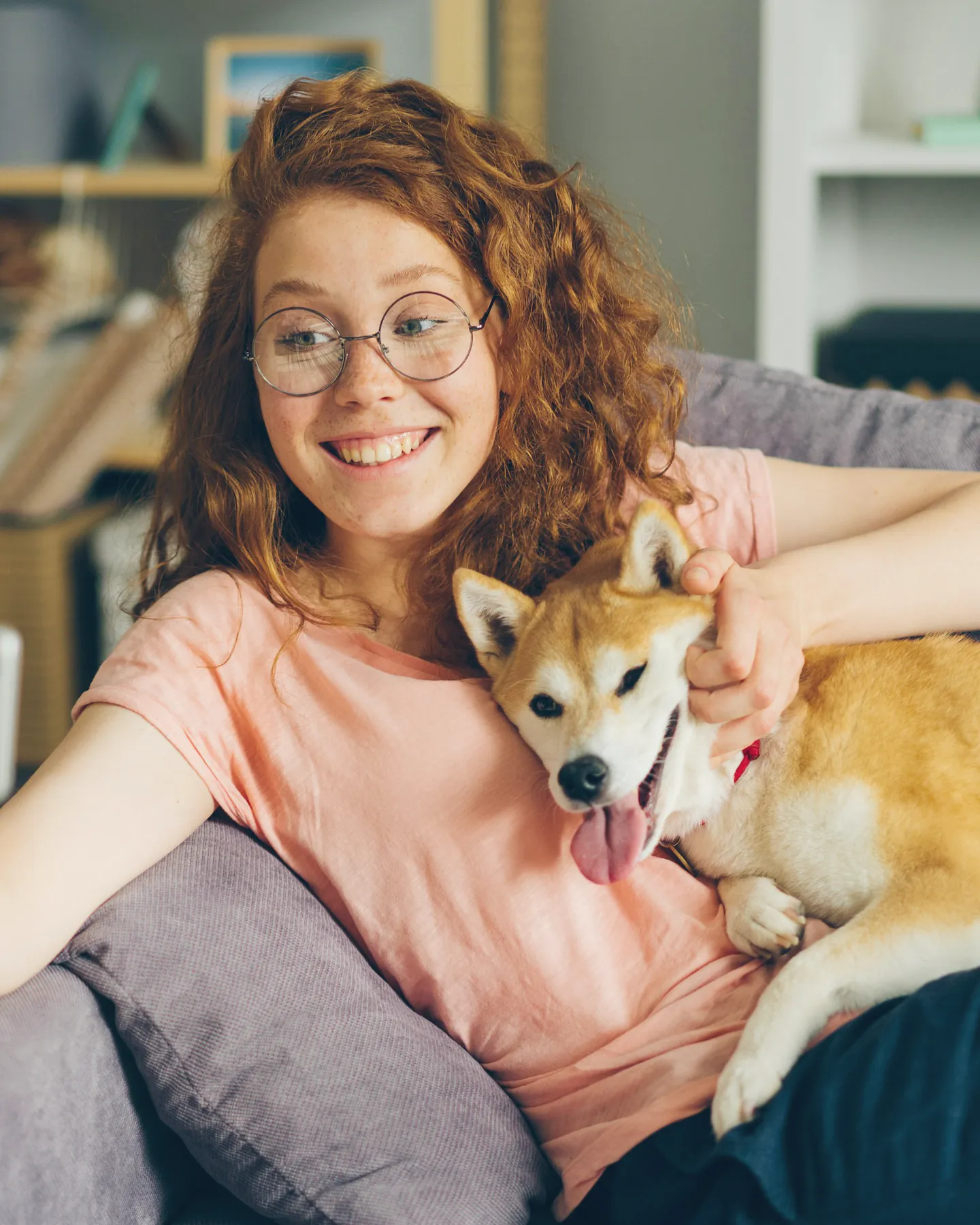 A walker on the couch with her shiba in her arms