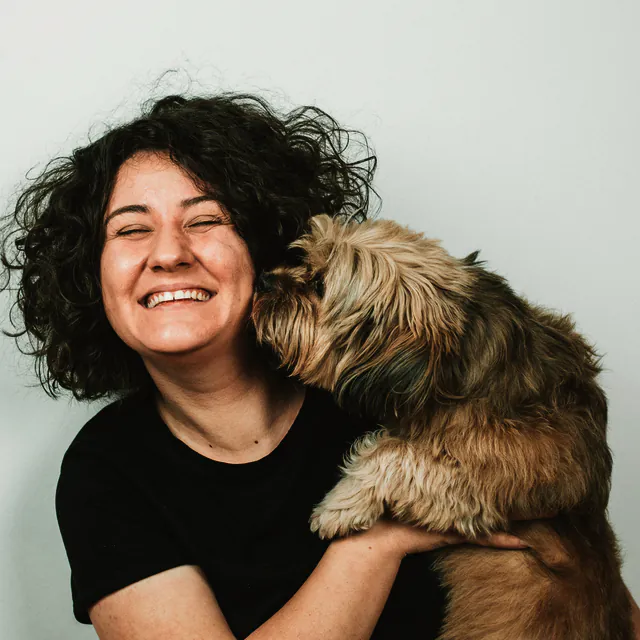 A dog giving its person a kiss